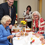 The Duchess of Cornwall holding an egg while discussing with members of the Ukrainian community