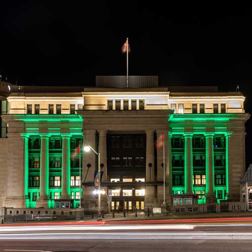 The Greek-like columns of the Senate Building are illuminated in emerald-green.