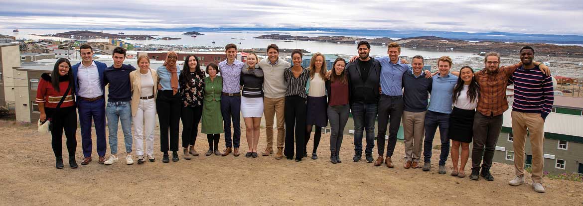 Prime Minister Justin Trudeau with Cohorts 3 and 4 of the Prime Minister's Youth Council with Iqaluit, Nunavut in the background.