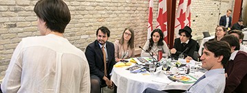 PMYC member presenting to Prime Minister Justin Trudeau