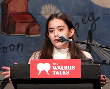 PMYC member speaking at a podium on stage