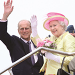 Her Majesty Queen Elizabeth II and The Duke of Edinburgh waving goodbye to the crowd.