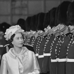 Black and white image of Queen Elizabeth II inspecting a guard of honour.