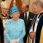 Queen Elizabeth II and the Duke of Edinburgh talking with two representatives of the St. James Cathedral.
