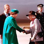 Queen Elizabeth II shaking hands with the Governor General Jeanne Sauvé. The Duke of Edinburgh is behind them. They are outside.