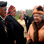 Queen Elizabeth II is introduced to men in a receiving line by Eber Hampton.