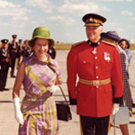 Queen Elizabeth II walking with the Commissioner of the RCMP.