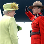 An RCMP member saluting Queen Elizabeth II.