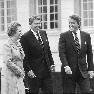 Margaret Thatcher, Brian Mulroney and Ronald Reagan walking side by side.