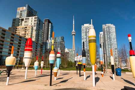 Colourful art installation with the Toronto skyline and CN tower in the background.