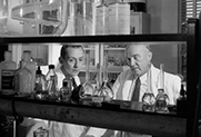 Dr. Charles H. Best and Dr. G.R. Williams check on experiments being conducted in the lab of the Charles H. Best Institute, University of Toronto.