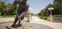 Photo of a bronze statue of Maurice Richard along a walkway in Jacques-Cartier Park