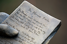 A close-up of the statue of John McCrae, highlighting the notepad where the poem In Flanders Fields was inscribed