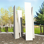 Close-up view of four tall granite pillars at the centre of the Memorial site