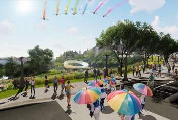 A large white ring suspended in the air touching the ground. Trees and green landscaping with people on a walkway carry rainbow parasols.