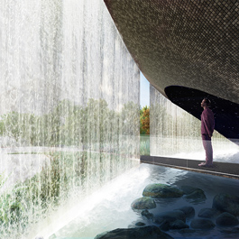 Person standing on a platform looking at a waterfall falling into a pool below. Landscaping through the waterfall.