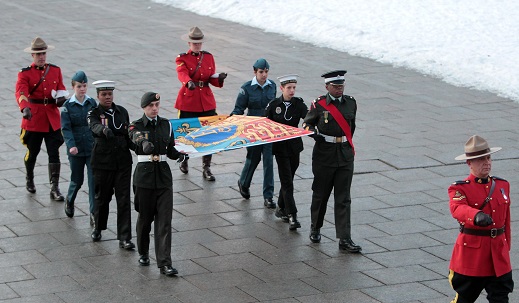 Cadets and members of the Royal Canadian Mounted Police prepare to raise The Queen's Personal Canadian Flag on Parliament Hill