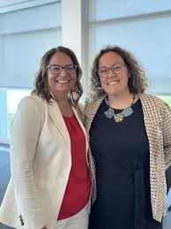 Rebecca Alty standing next to a Métis government official at her right side. Both are smiling