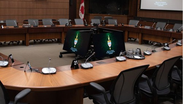 Seating layout of a committee meeting room with labeled sections for members, staff, witnesses and audience