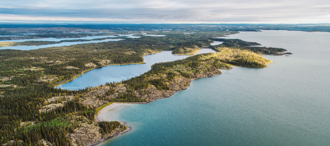 Aerial view of a river with forest around it, in the Slave Geological Province/North Slave Region
