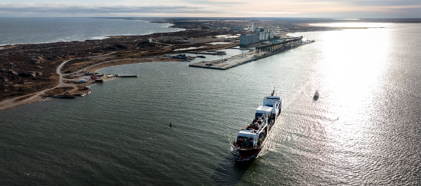 A ship in water, next to the Port of Churchill
