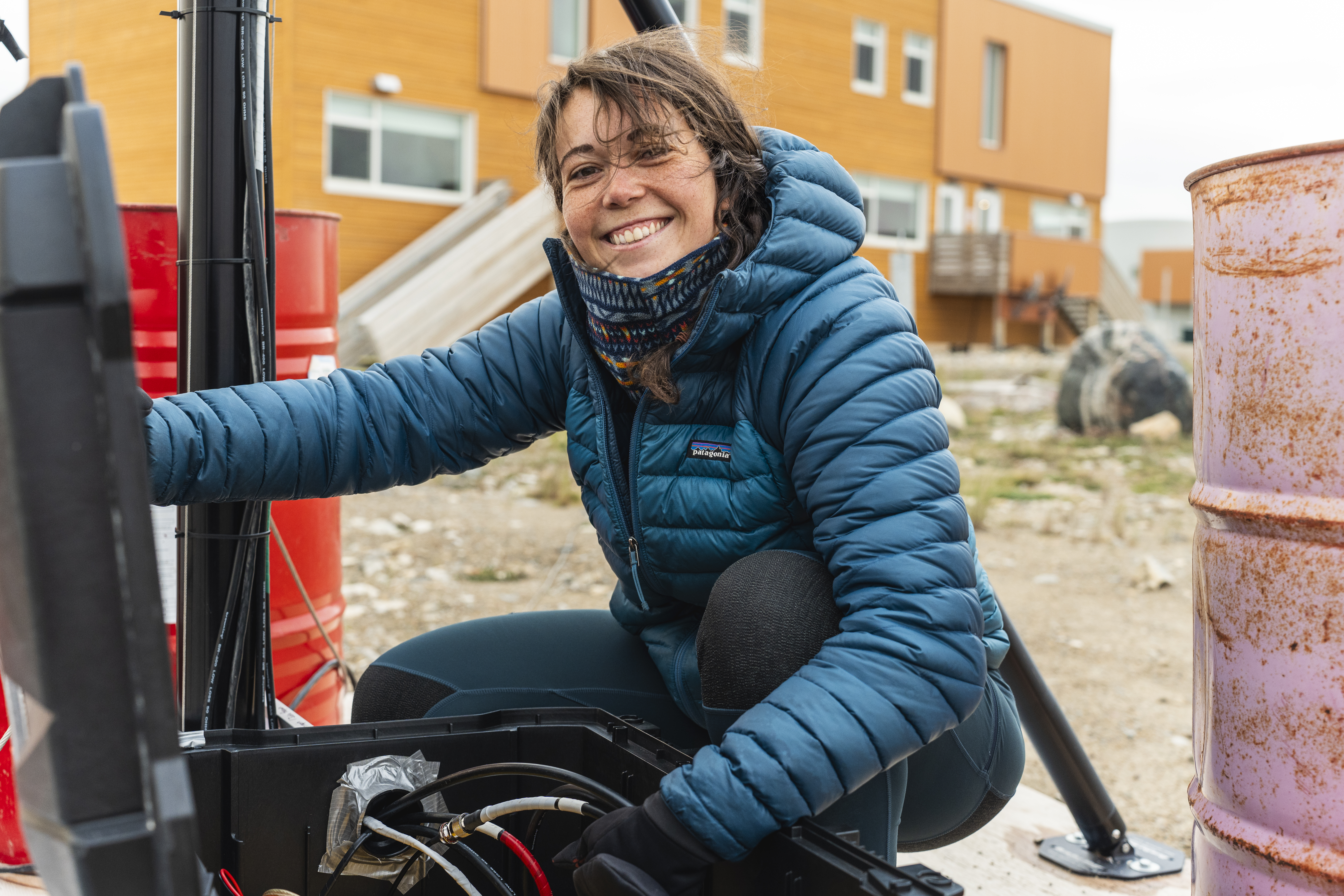 Photo inset of smiling woman crouched beside equipment.