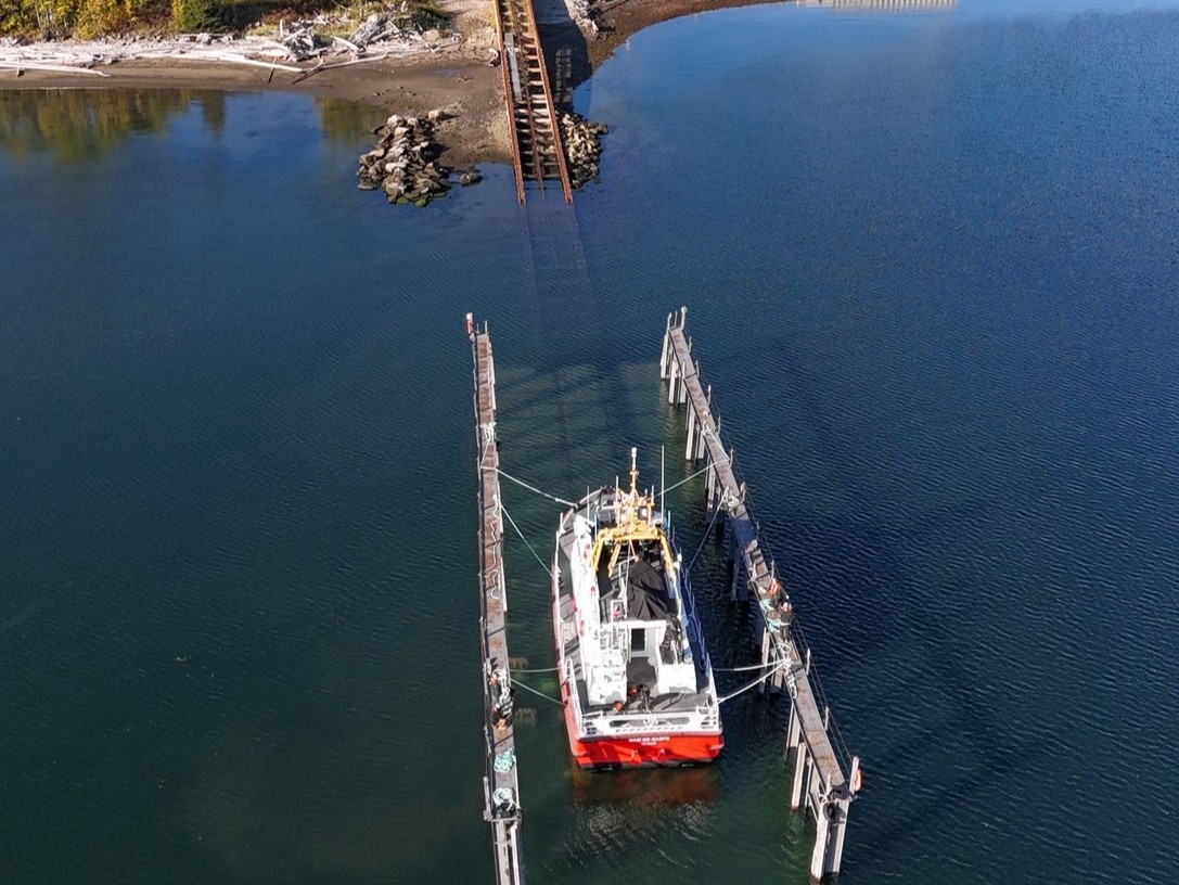 The Canadian Coast Guard Ship Baie de Gaspé being transferred from land to water with a boat ramp on the shore