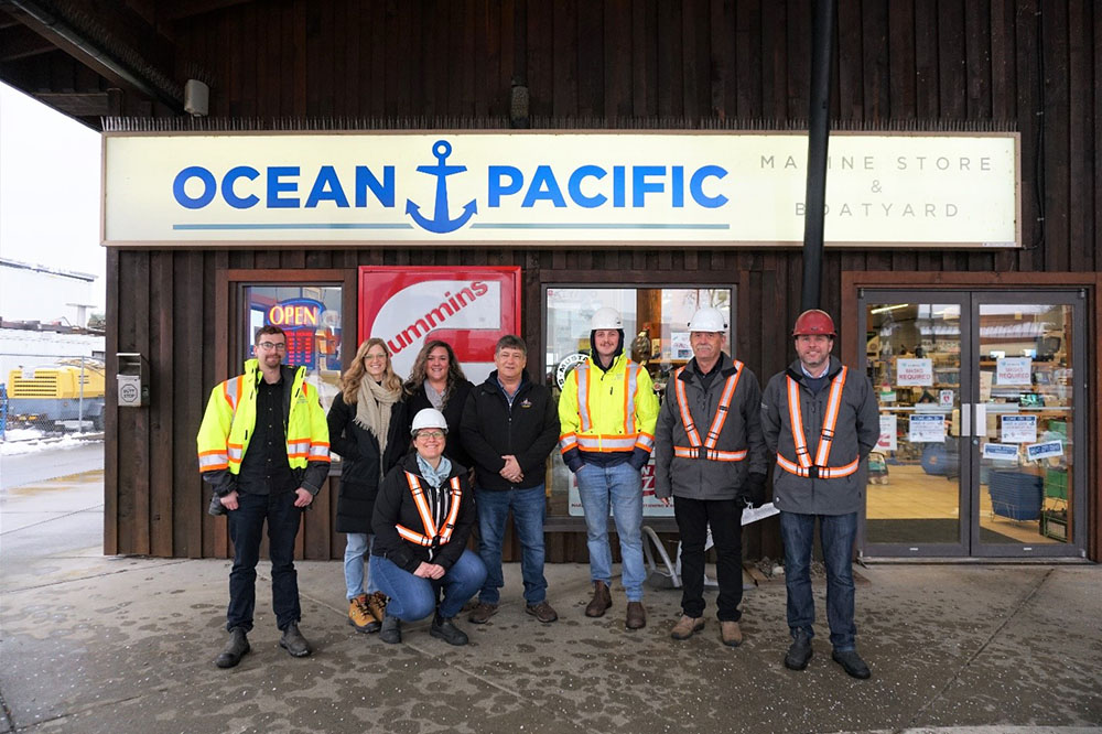 CA group of workers standing in front of the Ocean Pacific Marine Store