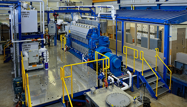A platform in a building with a large ship engine installed