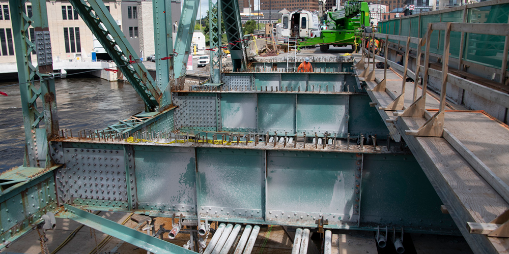 Construction workers working on a bridge structure.