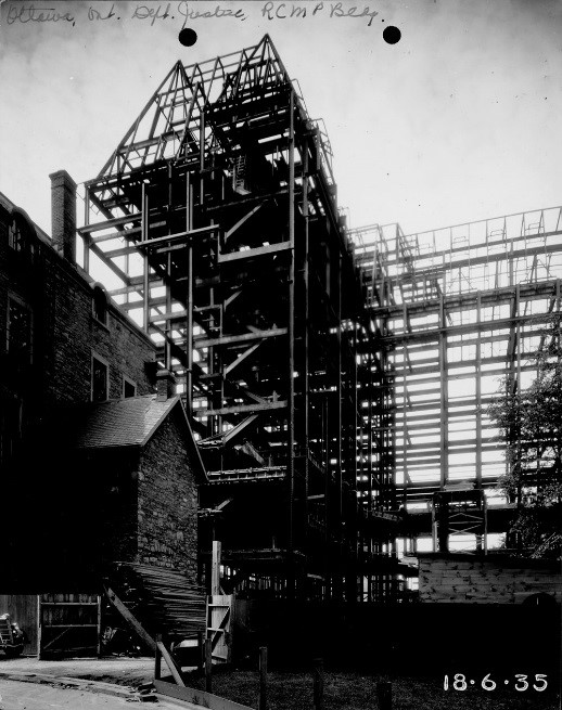 View enlarged image of a historical photo of the Justice building under construction.