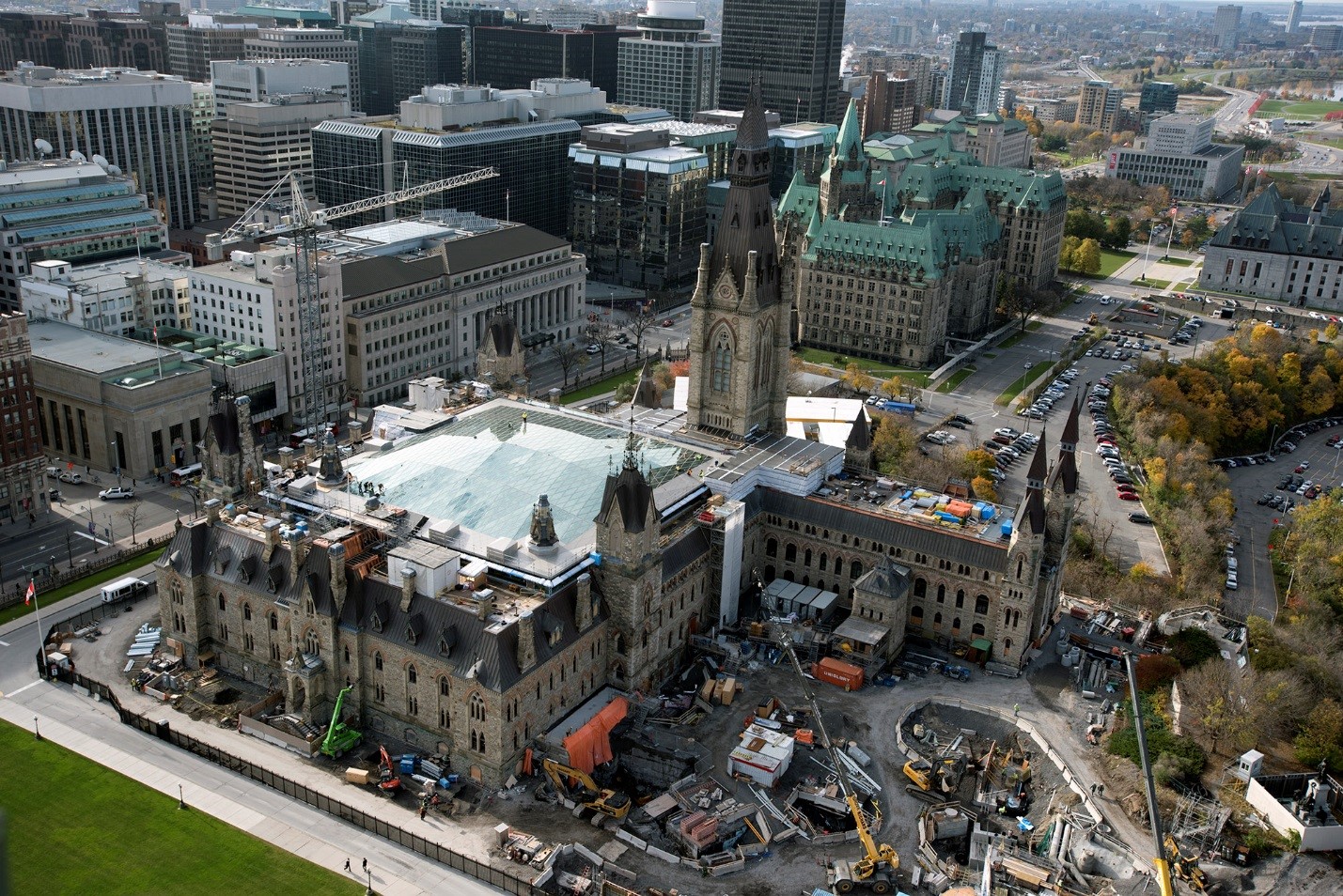 View enlarged image of an aerial photo of a building surrounded by construction vehicles and equipment.