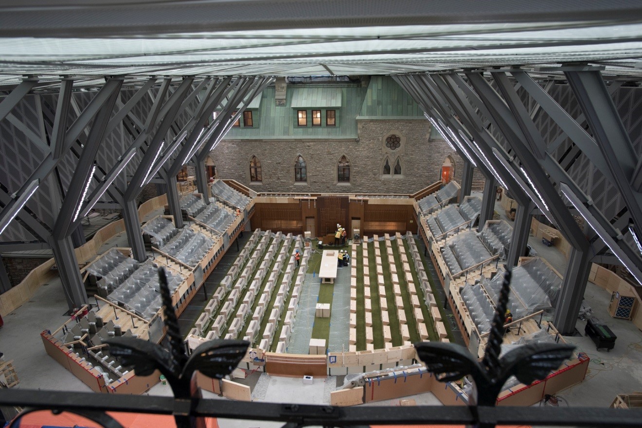 View enlarged image of a large room with stadium-style seating under construction.
