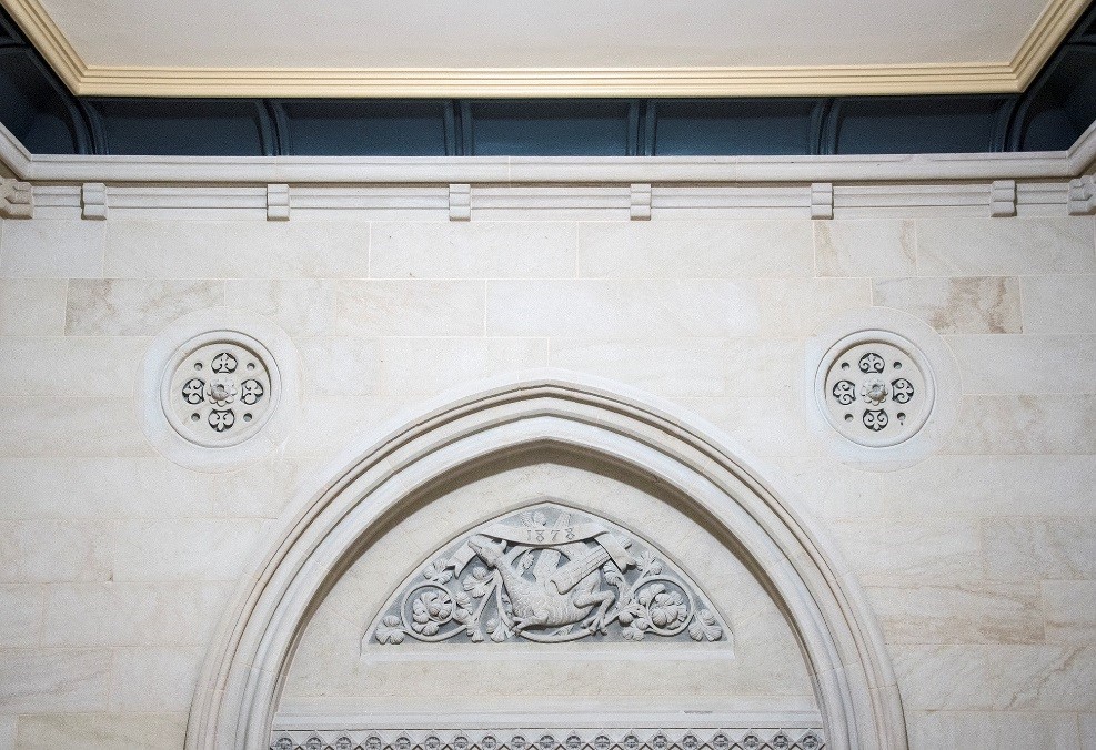 View enlarged image of stone carvings on the interior wall of a building.