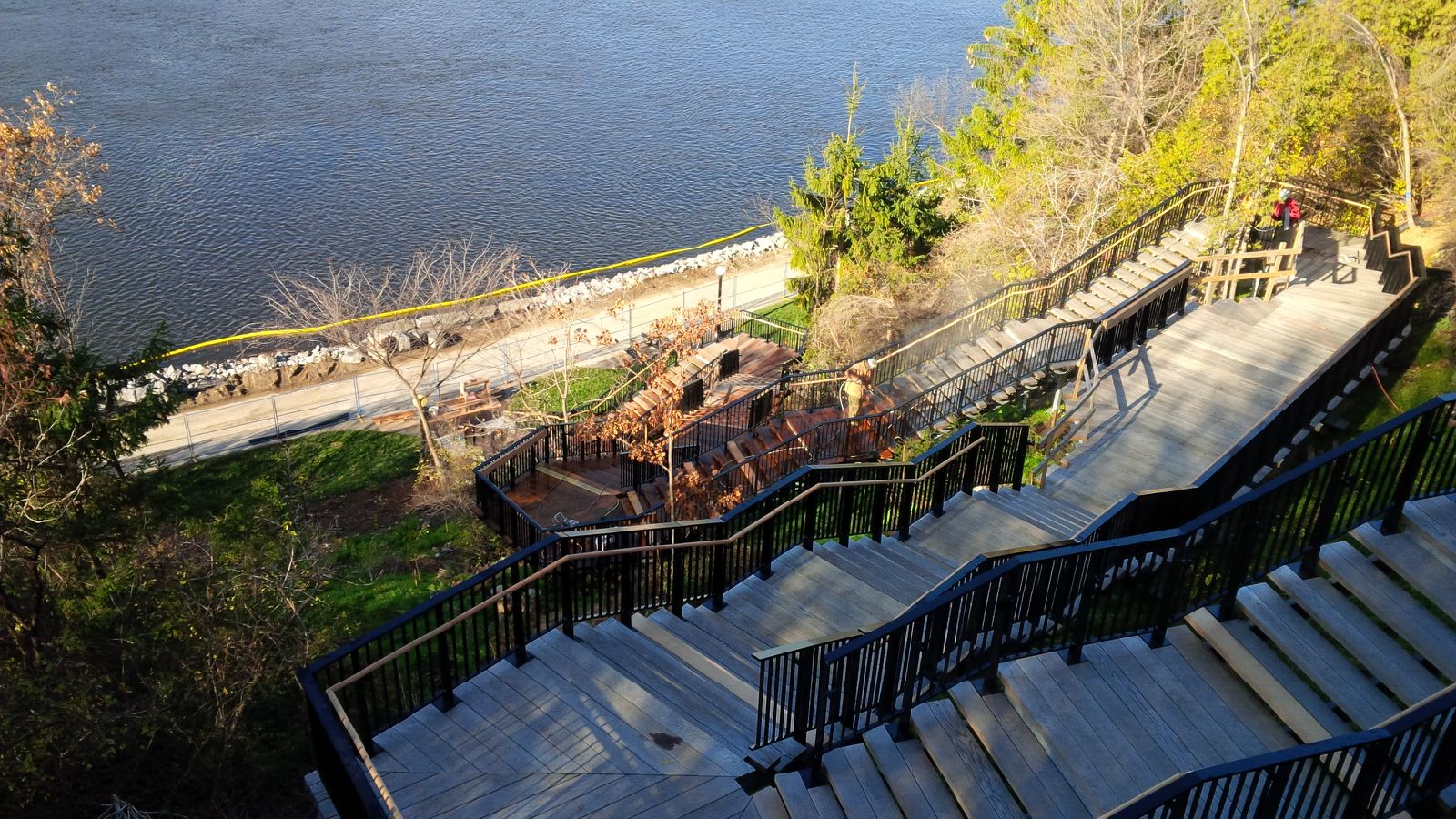 Overhead view of a worker staining the wooden staircase of Parliament Hill's northwest escarpment.