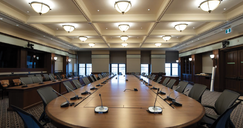 A modern boardroom in the West Block with a large table.