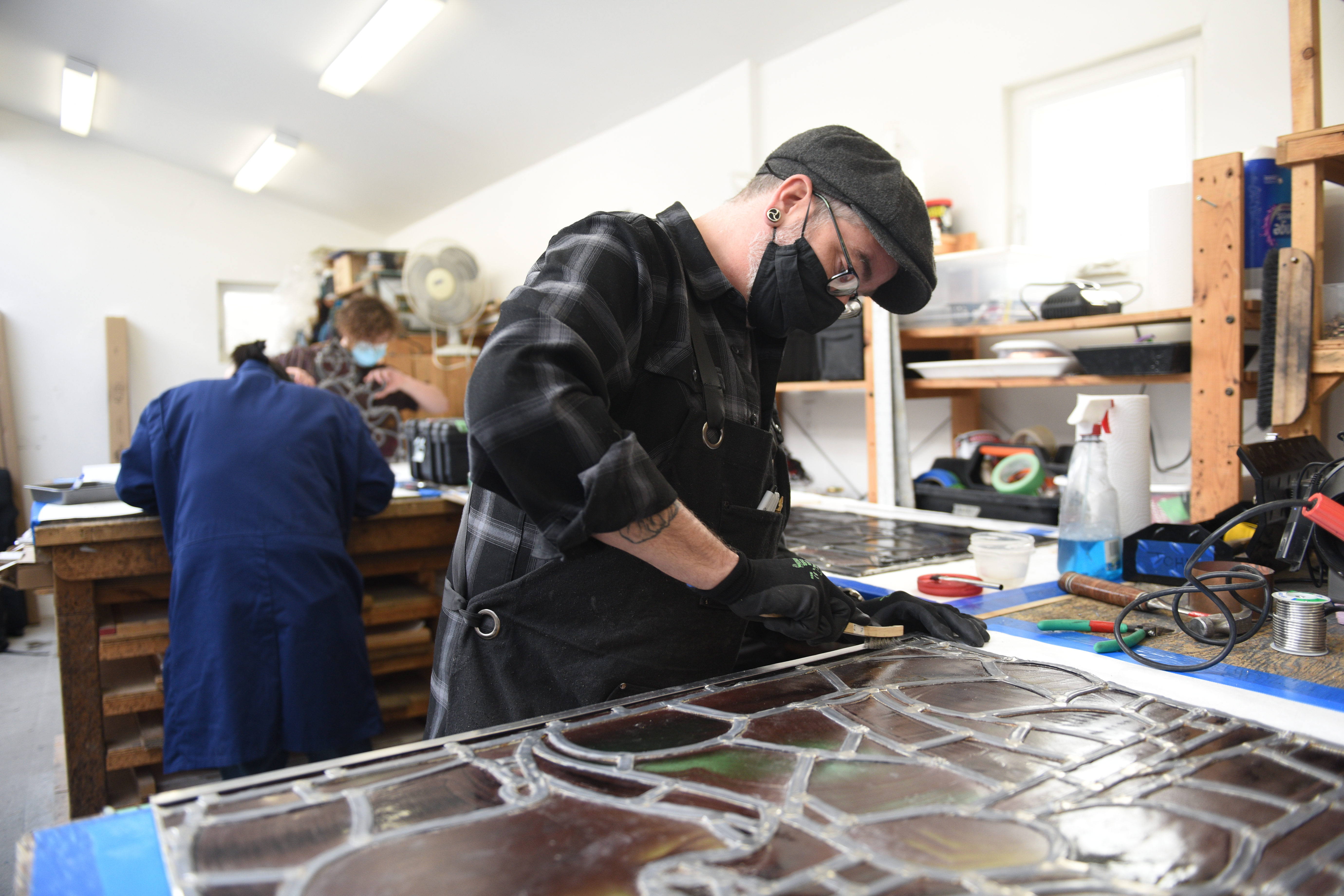 Conservators working to preserve and restore stained glass windows from the House of Commons Chamber