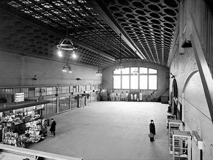 View enlarged image of a historical photo of a train station concourse with a coffered ceiling.