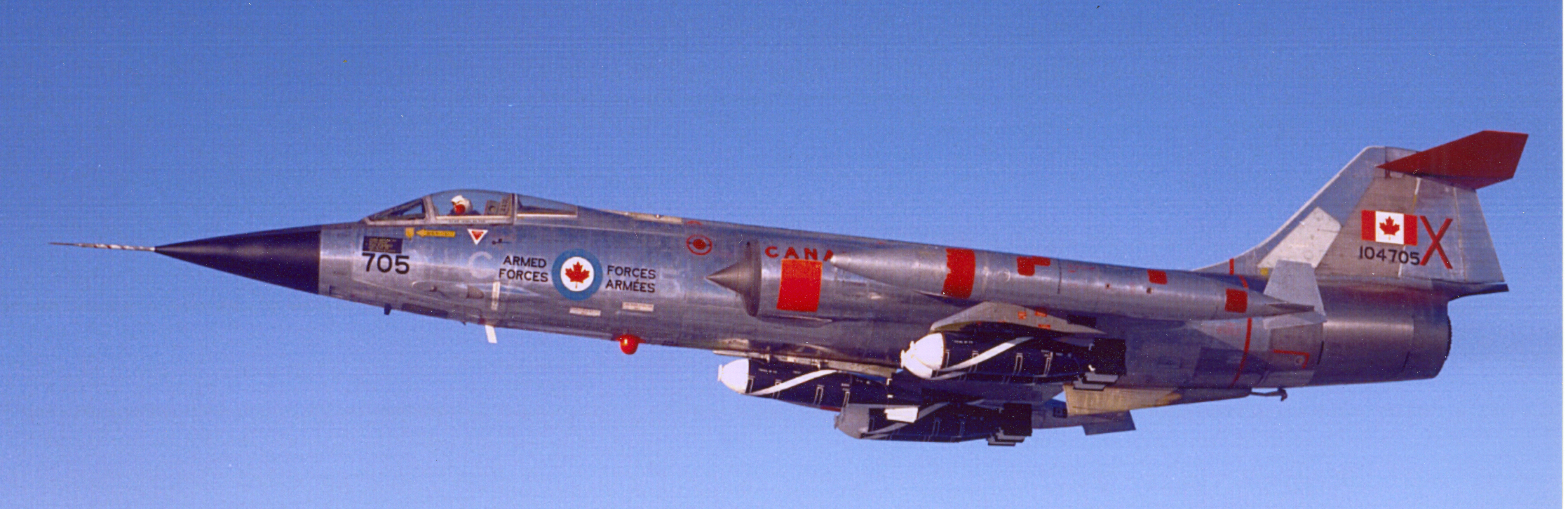 A dramatic view of a CF-104 Starfighter from the Aerospace Engineering Test Establishment carrying a full load of BL-755 cluster bombs. PHOTO: DND