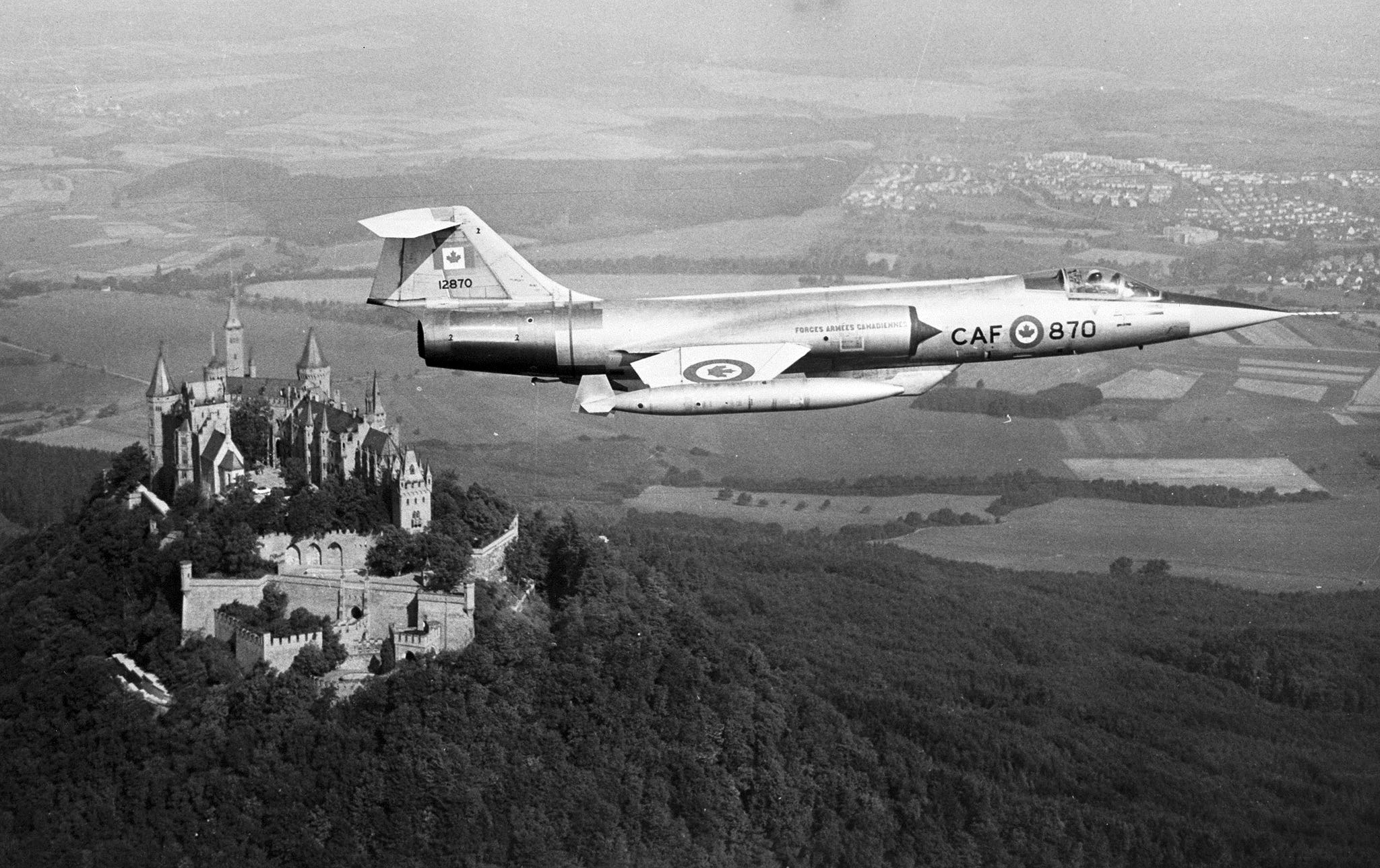 A CF-104 Starfighter from Canada's NATO-assigned No. 1 Air Division flies over Hohenzollern castle in the Federal Republic of Germany. The Air Division was equipped with six squadrons of the jet aircraft and based in Germany. PHOTO: DND Archives, IL69-64-1
