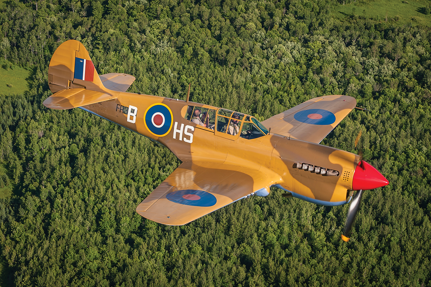 Vintage Wings of Canada’s “W/C Stocky Edwards P-40N Curtiss Kittyhawk” is painted in the same Desert Air Force markings of Wing Commander James “Stocky” Edwards’ North Africa-based 260 Squadron (RAF). In this photo, pilot Dave Hadfield soars over the Gatineau Hills with his father, Roger, on board. PHOTO: Peter Handley, Vintage Wings of Canada