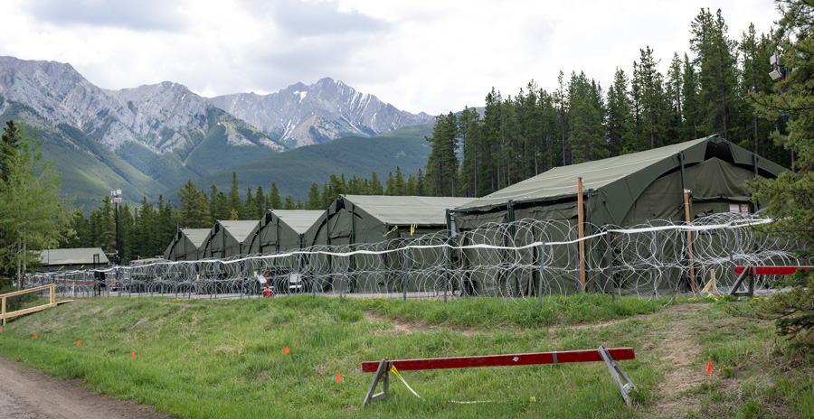 Overview of the Air Task Force Headquarters set up in a field location, with the Rocky Mountains visible in the backdrop.