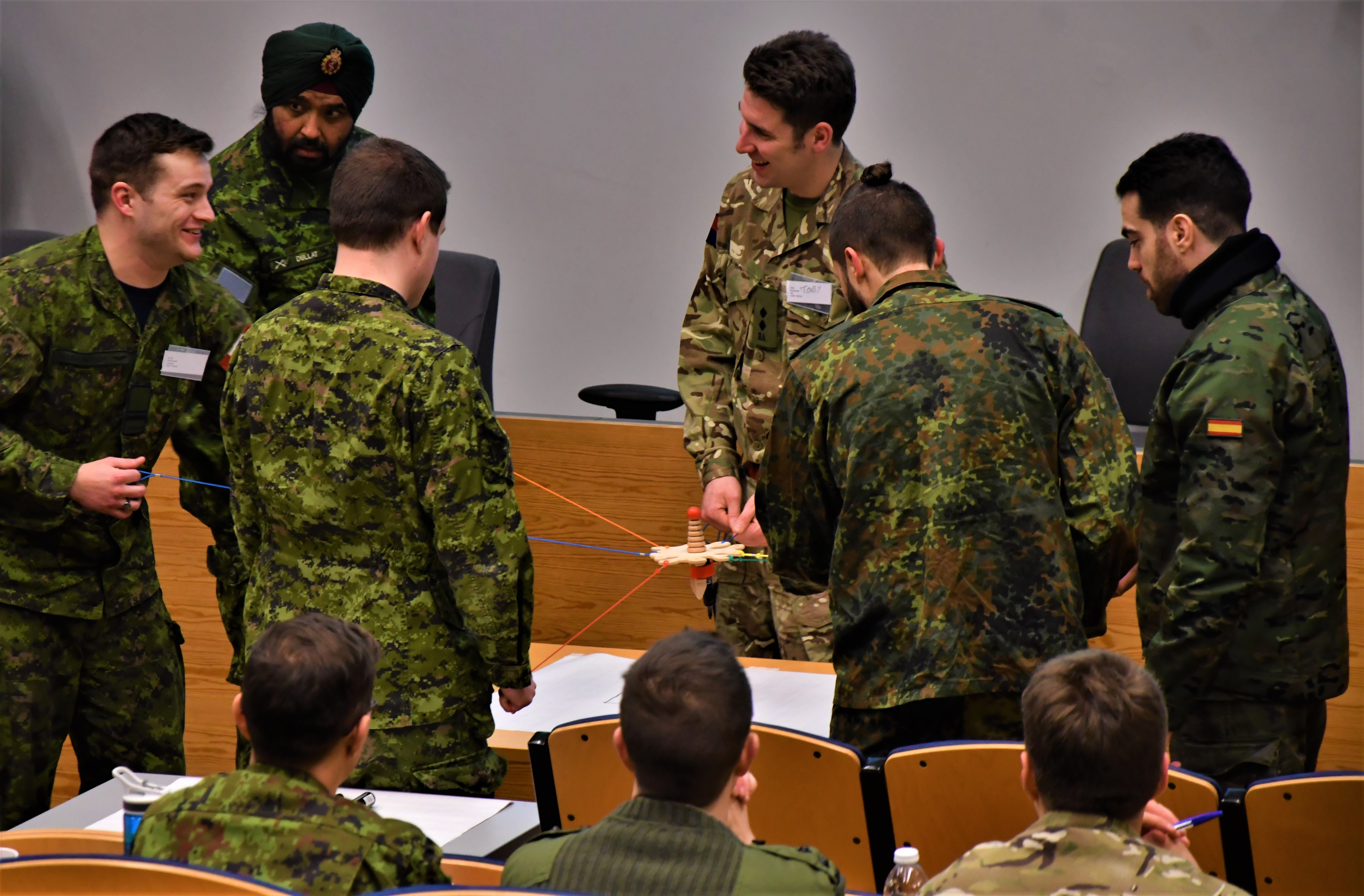 The workshop participants perform a group drawing activity together. Left to right: Lt Jared Mackintosh (Canada), Capt Charan Kamal Singh Dullat (Canada), Capt Scott McDowell (Canada), Lt Toby Broughab (United Kingdom), Lt Patrick Binding (Germany) and 2Lt Mario Bernus (Spain).