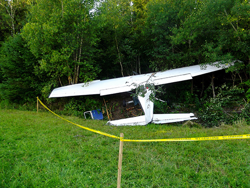 The aircraft could not outclimb the rising terrain and settled on the field before impacting trees at the end.