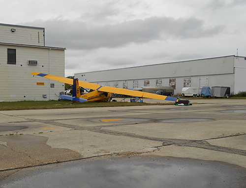 The glider came to an abrupt stop when it impacted the steel bollard surrounding a fire hydrant located 24 feet from the hangar.