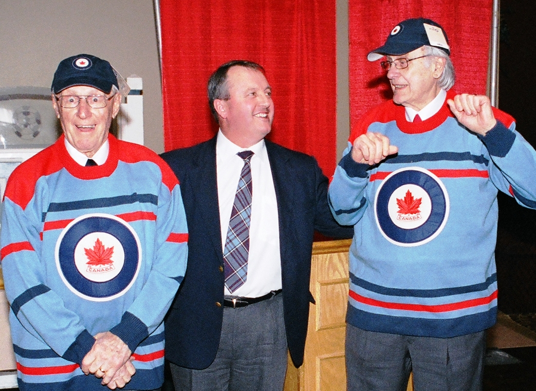 Former RCAF Flyers team mates Ab Renaud (left) and André LaPerrière show off their replica team jerseys presented by Dean Black (centre), executive director of the Royal Canadian Air Force Association, on February 8, 2008. PHOTO: Vic Johnson