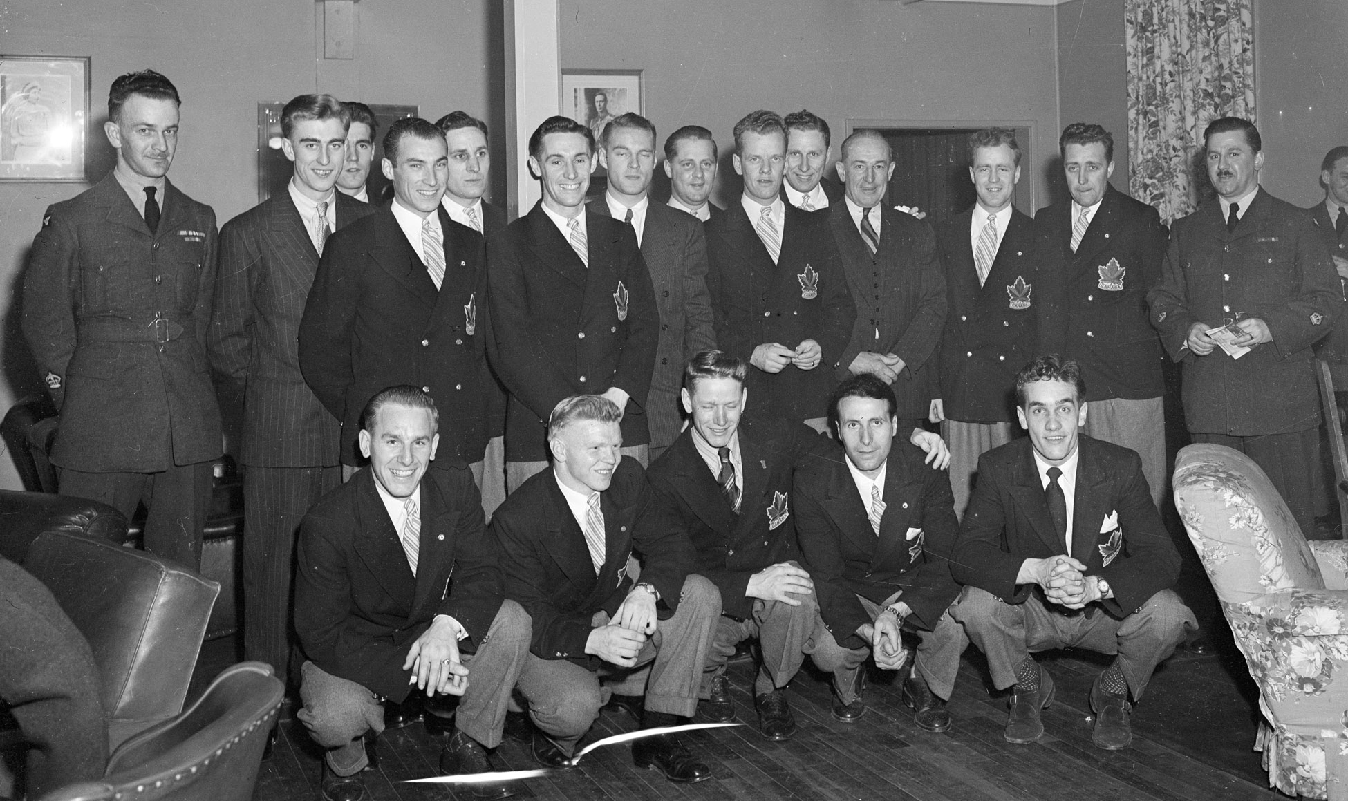 The Olympic Champions, RCAF Flyers, received a tremendous ovation onThursday, April 8, 1948, at the Sergeant's Mess located in Ottawa's Beaver Barracks. Front row (left to right): Reg Schroeter, Orval Gravelle, Roy Forbes, Patsy Guzzo and Ted Hibbert. Standing (left to right): Warrant Officer Class 2 W.H. Fader, vice-president of the mess. Murray Dowey, Pete Lietchnitz, Hubert Brooks, Frank Dunster, Ab Renaud, George Mara, Louis LeCompte, Ross King, Sandy Watson, George "Buck" Boucher, Frank Boucher, Corporal George McFaul and Warrant Officer Class 2 Colin Campbell. Absent from the photo are André Laperrière and Wally Halder. PHOTO: DND