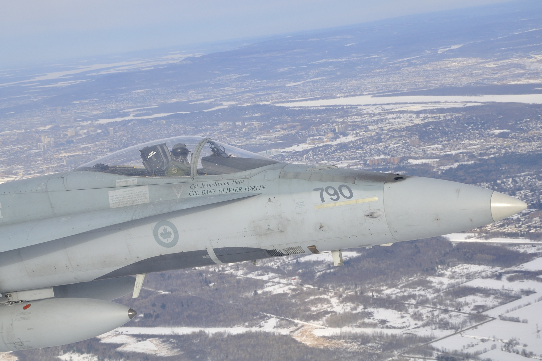 A CF-18 Hornet escorts a CC-177 Globemaster carrying Canadian Armed Forces members returning from the last mission in Afghanistan to the Ottawa International Airport on March 18, 2014. PHOTO: DND