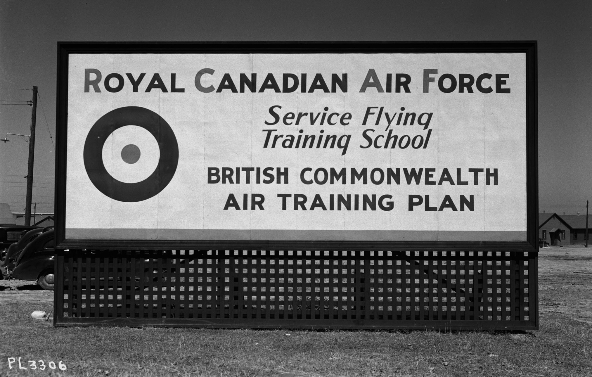 Signs such as this became part A large white sign with black lettering and an Air Force roundel in the corner.of the Canadian landscape as schools and airfields opened throughout the nation under the British Commonwealth Air Training Plan.