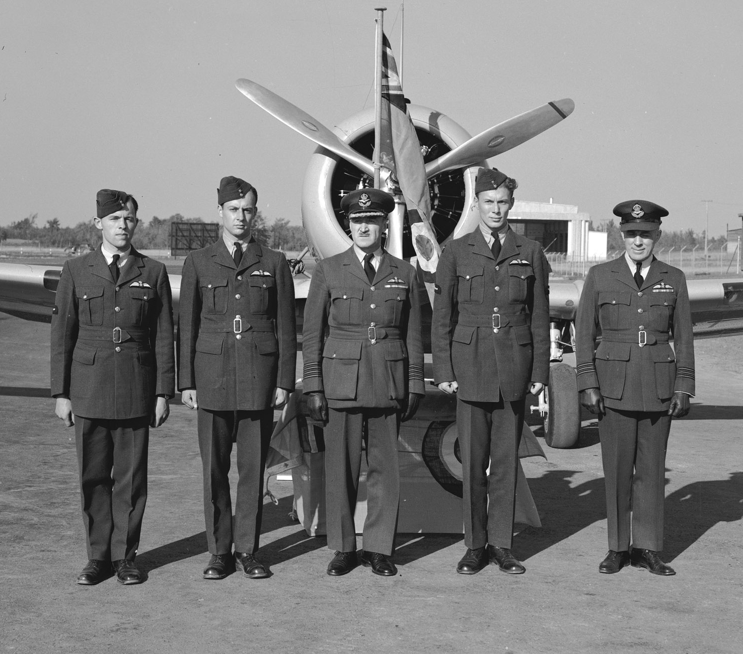 This 1940 photo portrays three leading aircraftmen who have just received their aircrew wings at Uplands near Ottawa. From left to right are Leading Aircraftman A.S. Johnson, Leading Aircraftman J.A. Thompson, Group Commander F.S. McGill, Leading Aircraftman J.J. Lawless and Wing Commander Elmer G. Fullerton. Less than two years after this photo was taken, Wing Commander Fullerton, by then promoted to the rank of Group Captain, would design the Royal Canadian Air Force’s tartan following a Robbie Burns dinner at Summerside, Prince Edward Island. PHOTO: PL-2232, DND Archives